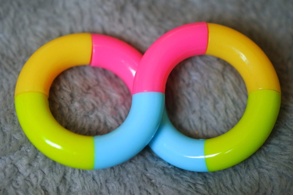 Photo for decoration: a sort of rainbow-ish Tangle, against a soft furry silver blanket.